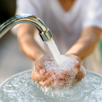 Kid washing his hands.